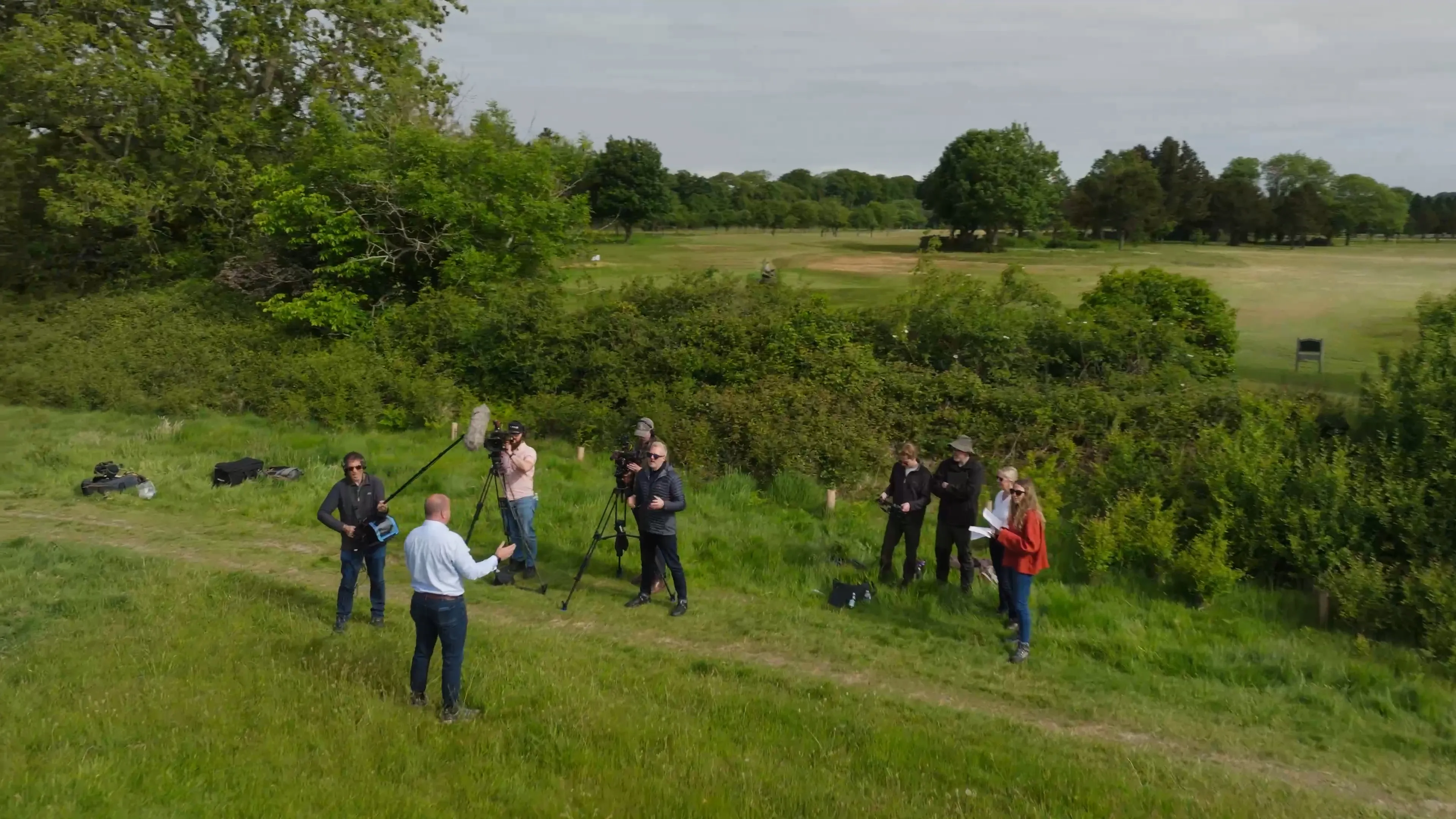 DotPerformance video production crew and Limehouse crew filming an interview on location in open countryside, with multiple crew members,  establishing shot for the Wildlife trust